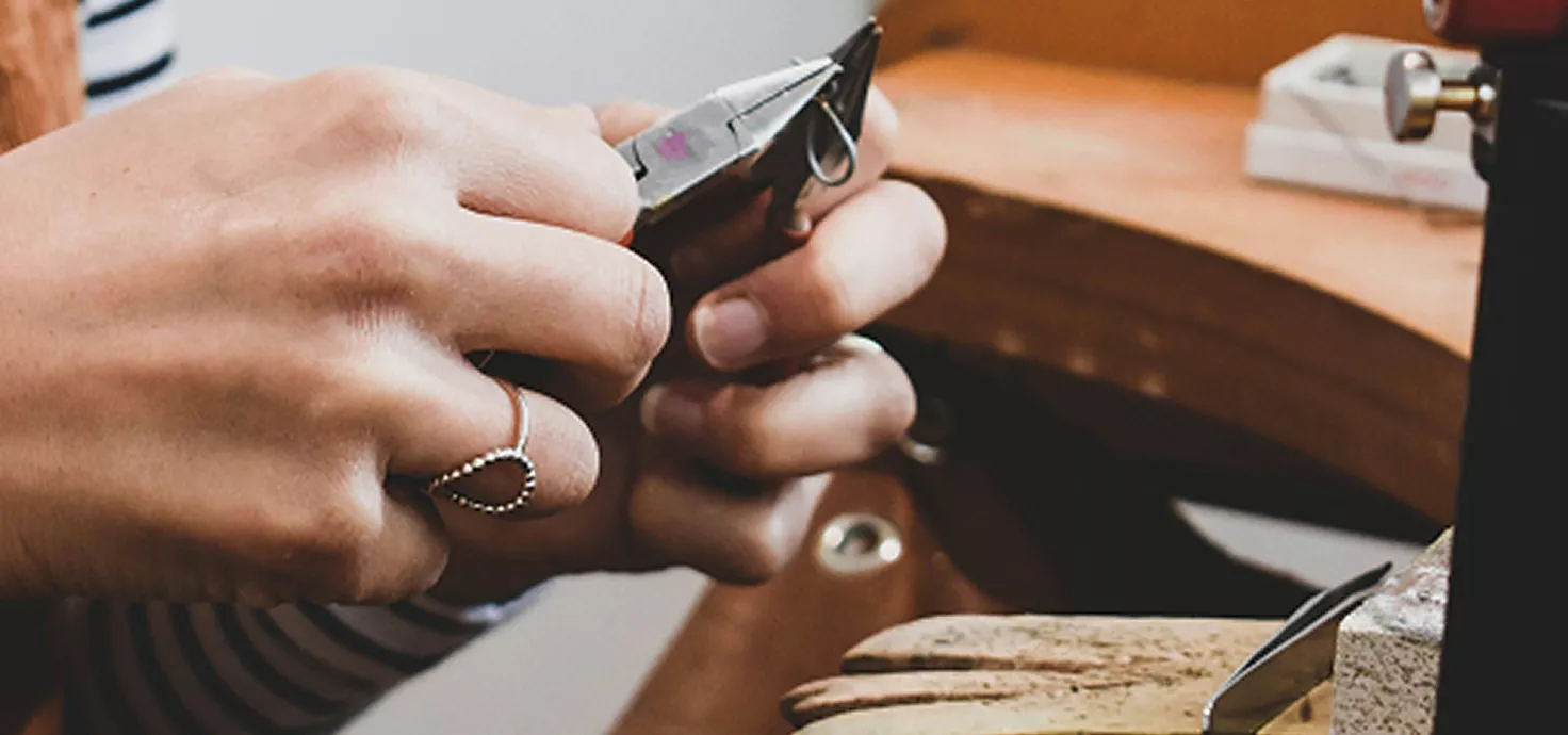 Rose gold jewelry collection with rhinestone bracelet and crystal earrings on white silk ribbon